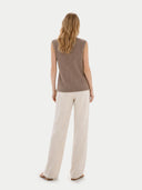 Back view of a woman wearing a brown sleeveless top and beige pants on a white background #color_taupe