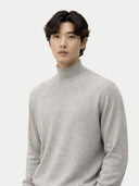 Man wearing a gray turtleneck sweater against a white background #color_dawn-blue