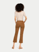 back view of brown corduroy pants and a white top on a white background #color_beige