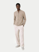front view of a man wearing a beige zip-up sweater and light-colored pants on a white background #color_taupe