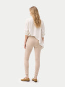 back view of a white blouse and beige pants on a white background #color_beige