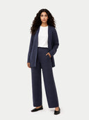 Woman wearing a navy suit with a white shirt on a white background #color_crown-blue