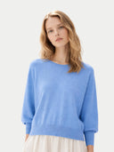 Woman wearing a light blue sweater on a white background #color_azure-blue