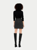 back view of a black top and gray skirt with black knee-high boots on a white background #color_charcoal