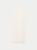 A plain off-white scarf with fringed edges, laid flat against a light gray background.