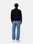 back view of a person wearing a navy sweater and blue jeans on a white background #color_navy-blazer