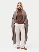 Model wrapped in the Cashmere Woven Blanket in Taupe, front view