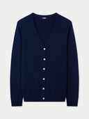 Navy blue v-neck cardigan with white buttons on a light gray background  #color_navy