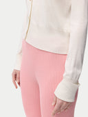  close up of a white cardigan and pink leggings #color_whisper-white