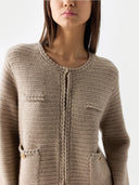 Close-up of a beige knitted cardigan on a white background #color_warm-grey