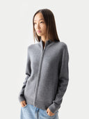 close up front view of a woman wearing a gray zip-up cardigan against a white background #color_dim-gray