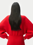 Back view of a zoomed picture, person wearing a red outfit with long black hair on a white background. #color_fiery-red