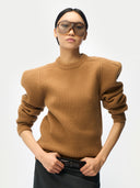 Person wearing a brown sweater and sunglasses on a white background #color_camel