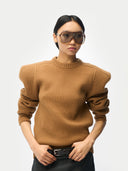 Woman wearing a brown ribbed sweater and sunglasses on a white background #color_camel