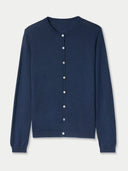 Navy blue crew neck cardigan with white buttons on a light gray background #color_mood-indigo