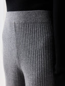 Close up of gray ribbed pants with a black top on a white background #color_dim-gray