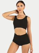 A woman wearing a black cashmere bralette and matching shorts. #color_black