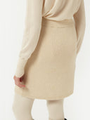 back view of a beige mini skirt with ribbed texture #color_off-white