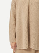 close up of a beige sweater #color_warm-grey