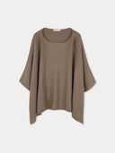 flat lay of a brown poncho on a light gray background #color_taupe