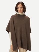 close up front view of a woman wearing a brown crew neck poncho over a white sweater #color_cocoa