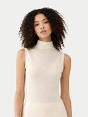 Woman wearing a white sleeveless dress against a plain background #color_marshmallow
