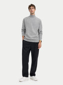 front view of a Man wearing a gray sweater, black pants, and white shoes on a white background #color_vapor-blue