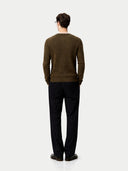 Back view of a man wearing a brown sweater and black pants on a white background #color_cub