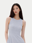 Woman wearing a light gray sleeveless dress against a white background #color_ice-flow