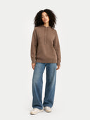 front view of woman wearing a brown hoodie and blue jeans on a white background #color_taupe