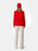 back view of a red sweater and white pants on a white background #color_hibiscus