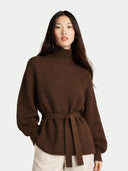Woman wearing a brown ribbed sweater with a belt on a white background