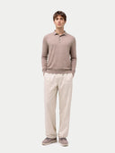 Man wearing a brown long-sleeve polo shirt and beige pants on a white background #color_taupe