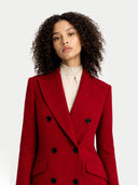 Woman wearing a red coat with black buttons on a white background #color_bordeaux