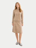 Woman wearing a beige sweater and skirt set on a white background #color_warm-grey