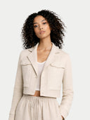 Woman wearing a beige jacket and pants on a white background #color_off-white