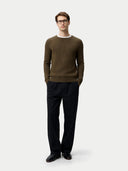 Man wearing a brown sweater and black pants on a white background #color_cub