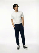Person wearing a white t-shirt and navy jogger on a white background #color_navy-blazer