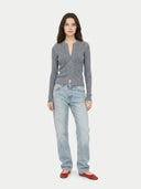 front view of a woman wearing a gray ribbed cardigan and light blue jeans on a white background #color_all
