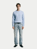 Man wearing a light blue sweater and jeans on a white background #color_light-blue