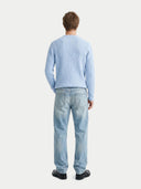 Man wearing a light blue sweater and jeans on a white background #color_light-blue