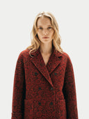close up of a woman wearing a red florals double breasted coat on a white background #color_red