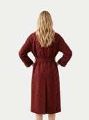 back view of a red patterned dress with a belt on a white background #color_red