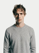 Men's Grey Crewneck Cashmere Sweater worn by model, detail view on white background