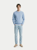 front view of a man wearing a light blue round neck sweater and jeans on a white background #color_light-blue