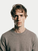close up front view of a man wearing a taupe-colored crew neck sweater against a white background  #color_taupe
