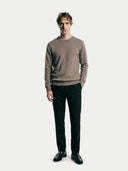 front view of a man wearing a brown crew neck sweater and black pants on a white background  #color_taupe