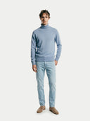 front view of a man wearing a light blue turtle neck sweater and jeans on a white background #color_light-blue
