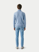 back view of a man wearing a light blue turtle neck sweater and jeans on a white background #color_light-blue