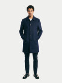 front view of a man wearing a navy blue coat on a white background. #color_navy